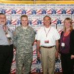 PIA of Wisconsin presented over 4,000 donated cell phones as part of the Cell Phones for Soldiers program during the association's trade show in 2011. A U.S. Soldier (center) accepted the donation from (left to right) PIA members Alan Breitenfeldt, Dennis Kuhnke and Kori Sagen.