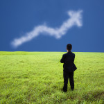 Businessman stand in the meadow and watch the business profit gr